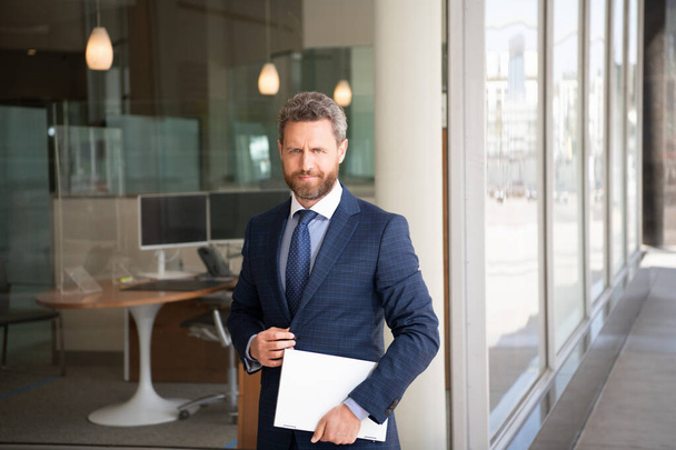 mature smiling businessman in businesslike suit hold wireless laptop outside the office, business - Fotó, kép