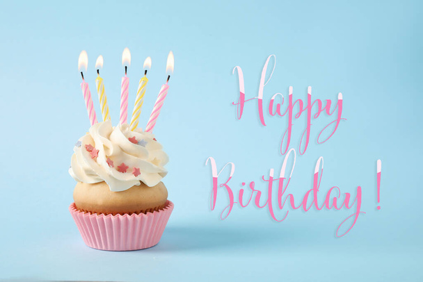 Happy Birthday! Delicious cupcake with candles on light blue background  - Φωτογραφία, εικόνα