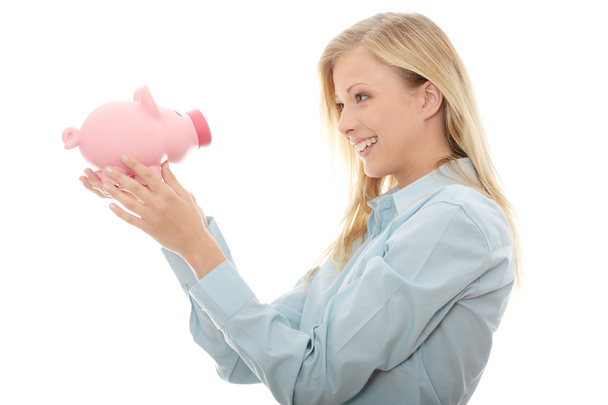 Businesswoman holding piggy bank - Fotoğraf, Görsel