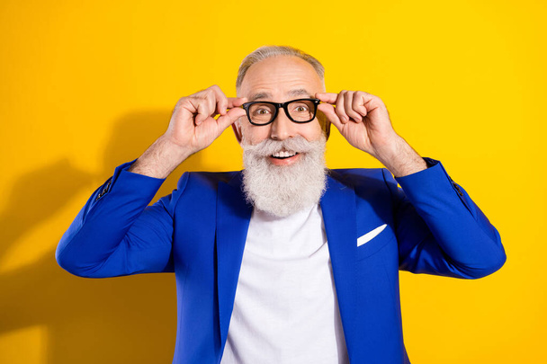 Photo of amazed happy excited old man wear glasses good mood sale isolated on yellow color background - Photo, image