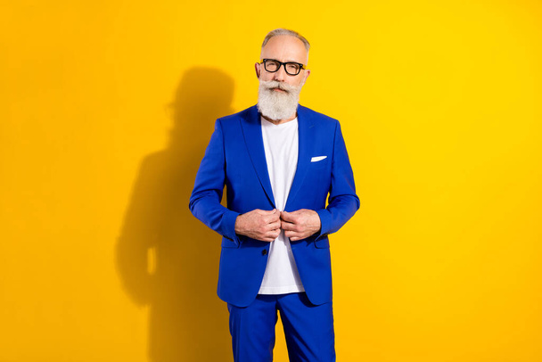 Photo portrait of businessman wearing blue tuxedo glasses serious face strict isolated on bright yellow color background - Zdjęcie, obraz