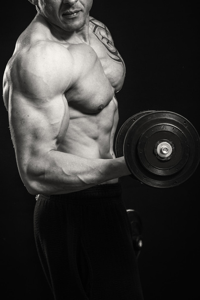 Muscle man with dumbbells - Photo, image