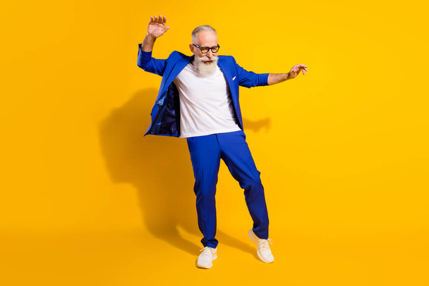 Full body photo of crazy positive person dancing have good mood weekend isolated on yellow color background - Foto, immagini