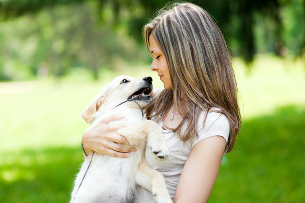 Girl with her dog outdoors - Фото, зображення