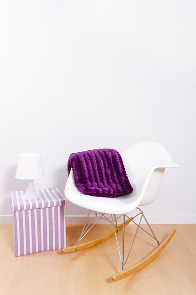 Moderna sedia a dondolo bianca e parete
 - Foto, immagini