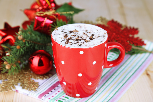 Hot chocolate with cream in color mug, on table, on Christmas decorations background - Zdjęcie, obraz