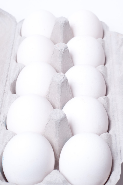 Eggs in pack on white background - Foto, Imagen