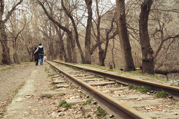 Young couple walking far away on railroad together - Valokuva, kuva