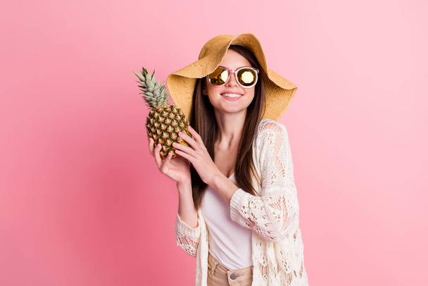 Photo of charming satisfied lady arms hold demonstrate pineapple toothy smile isolated on pink color background - Фото, изображение