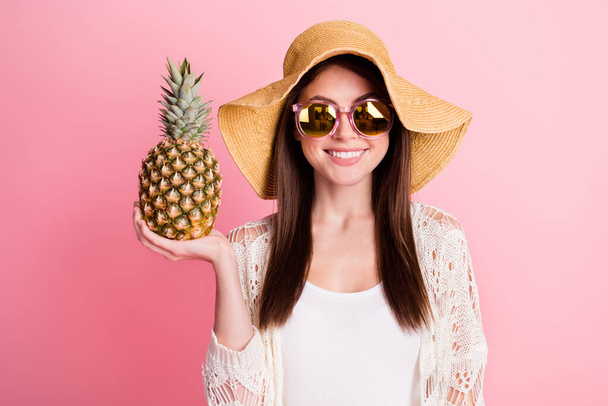 Portrait of charming cheerful girl hand hold pineapple beaming smile isolated on pink color background - Photo, image