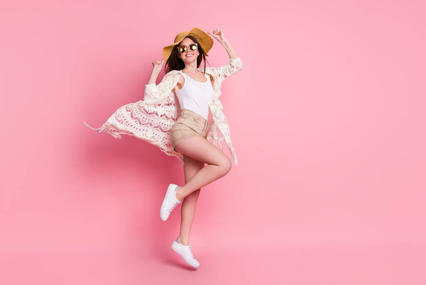 Photo of charming shiny young woman dressed white cardigan headwear jumping high isolated pink color background - Φωτογραφία, εικόνα