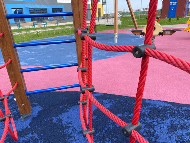 Children's new modern sports playground with various activities, games, swings, slides, carousels and sandpits with a rope town in the open-air courtyard. - Photo, Image