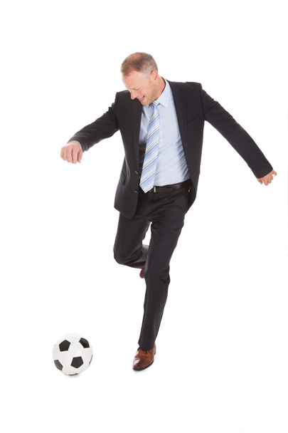 Businessman Kicking Soccer Ball - Foto, immagini