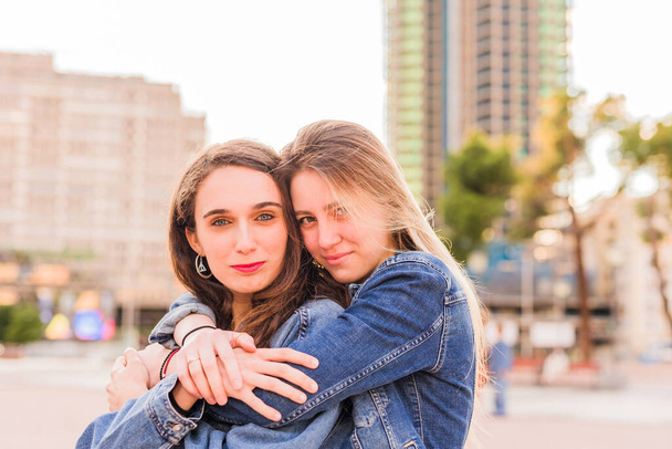 Giovane coppia multietnica lesbica si abbraccia su un'alba. Insieme ragazze di felicità  - Foto, immagini