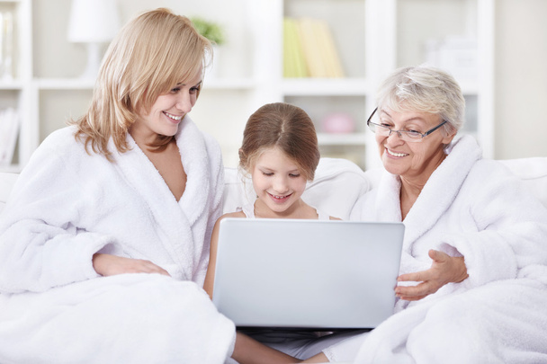Famille attrayante est à la recherche dans un ordinateur portable
 - Photo, image