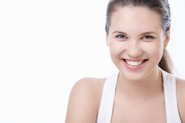 Young smiling girl on white background - Fotografie, Obrázek