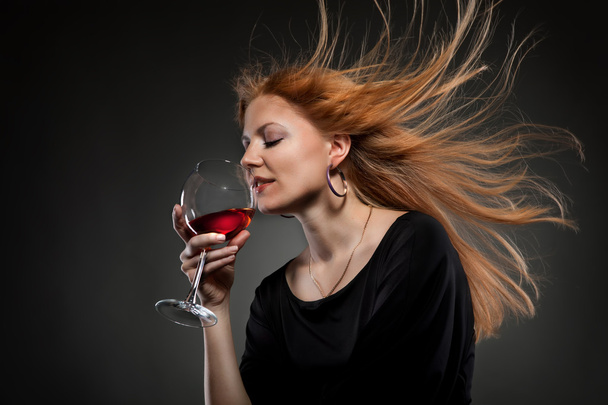 Woman with red hair holding wine glass - Фото, изображение