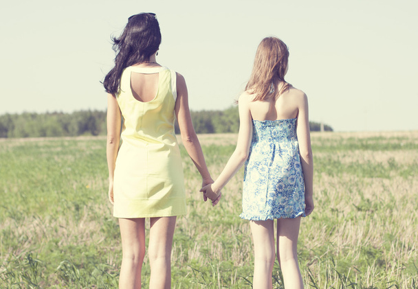 Mother and daughter standing in a field - Foto, Imagen