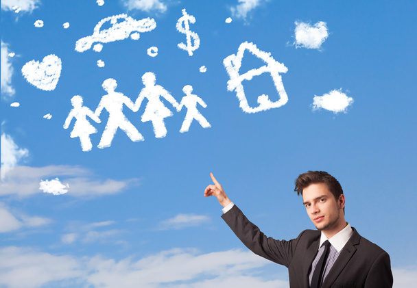 Businessman daydreaming with family and household clouds  - Photo, Image