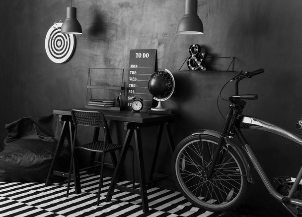 Interior of stylish room with modern workplace and bicycle - Φωτογραφία, εικόνα
