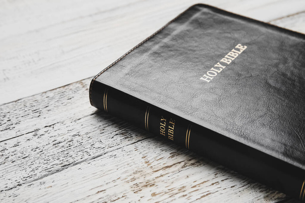 Holy Bible on light wooden background, closeup - Φωτογραφία, εικόνα