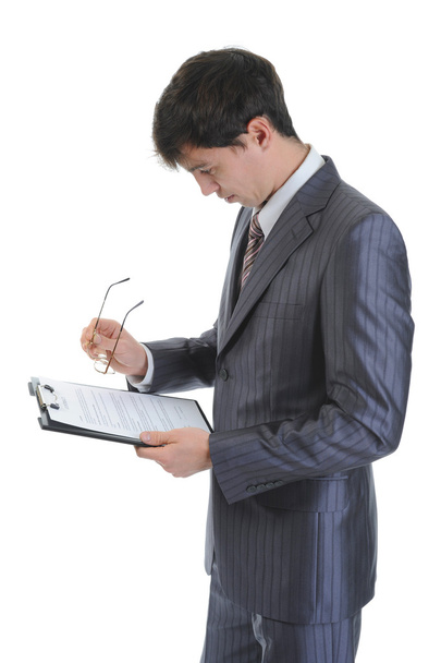 Businessman holding a clipboard. Isolated on white background - Valokuva, kuva