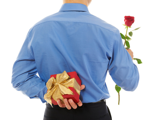 Man with a gift box and a rose. Isolated on white background - Valokuva, kuva