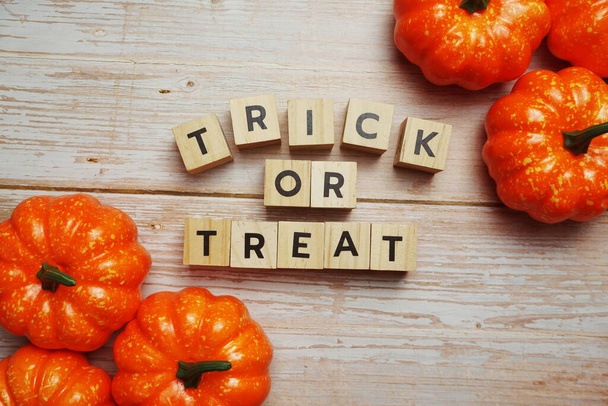 Trick or Treat alphabet letter with pumpkin decoration on wooden background - Фото, зображення