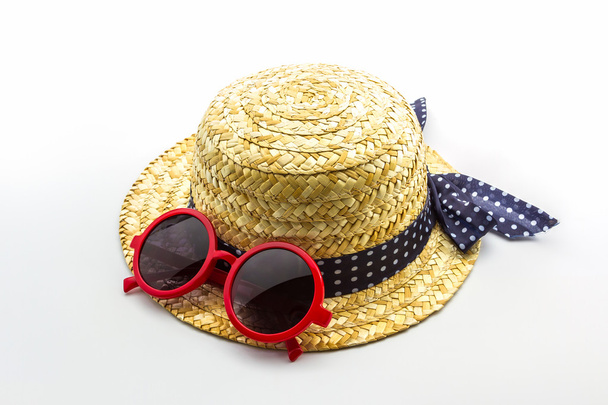Woven hat with red sunglasses. - Photo, image