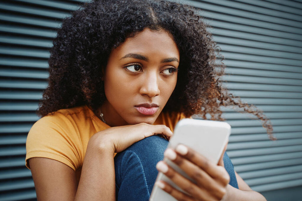 Jeden sám černošky mladá žena drží mobilní telefon - Fotografie, Obrázek