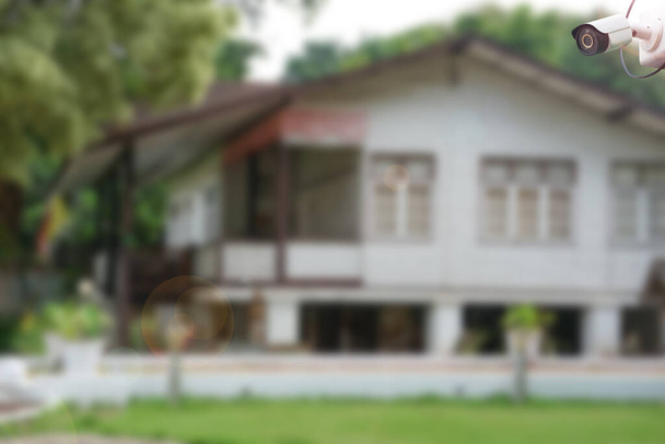 CCTV security camera with background blurred house and lens flare edited. concept home security surveillance                                - Photo, Image