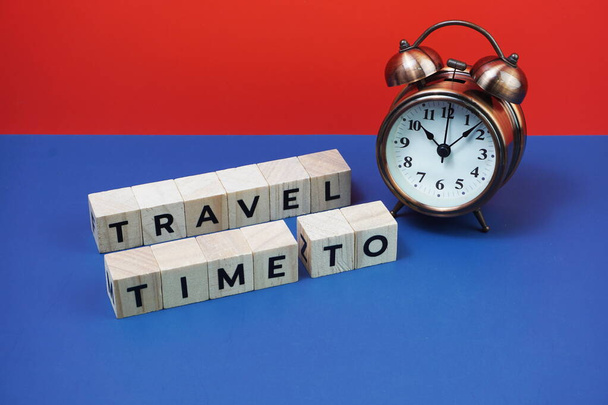Time to Travel alphabet letter with alarm clock on blue and red background - Foto, Imagem