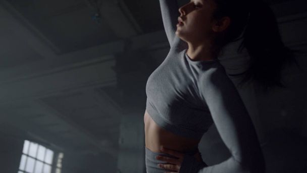 Woman doing side bends during training. Athlete warming body before workout - Valokuva, kuva