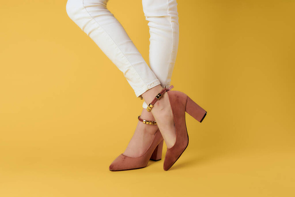 legs in  shoes  close-up yellow background. High quality photo - Fotó, kép