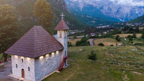 Καθολική Εκκλησία στο χωριό Θέθ της Προκλετίε στα Καταραμένα Βουνά της Αλβανίας. Η κοινότητα βρίσκεται στο κέντρο του Theth National Park, μια περιοχή εξαιρετικής φυσικής ομορφιάς. - Φωτογραφία, εικόνα