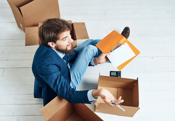 business man in office moving,  unpacking things. High quality photo - Foto, afbeelding