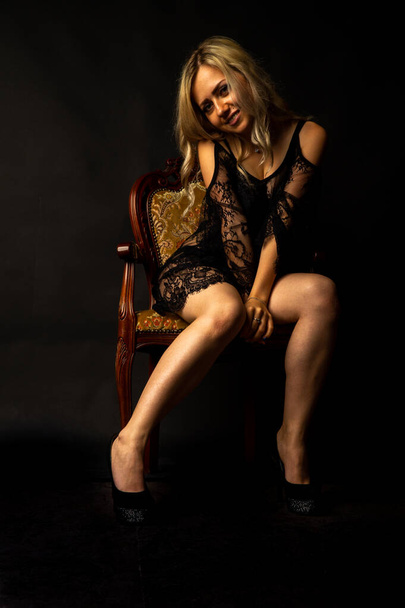 sexy beautiful blonde woman in lingerie posing at dark studio   - Zdjęcie, obraz