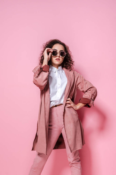 Young elegant woman in trendy pink coat. isolated studio shot - Foto, Imagen