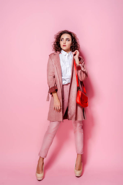 Young elegant woman in trendy pink coat. isolated studio shot - Fotoğraf, Görsel