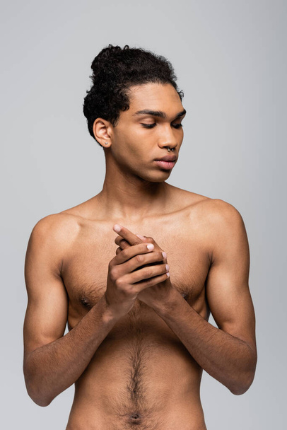 shirtless, pierced african american man standing isolated on grey, beauty concept - Foto, imagen