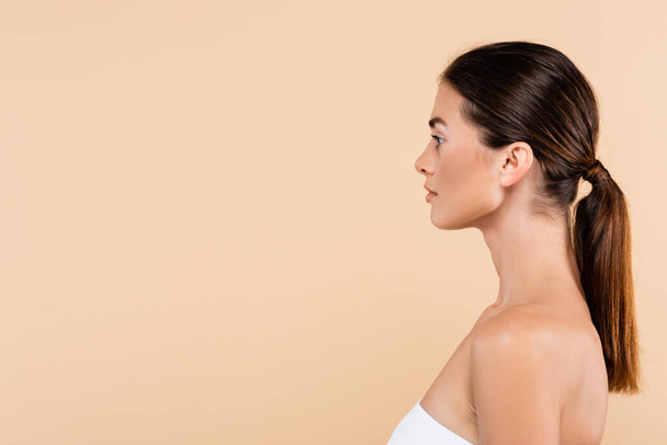 side view of pretty brunette woman isolated on beige, beauty concept - Photo, image