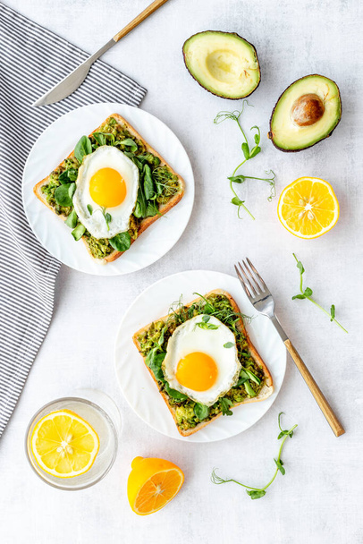Sandwich with eggs avocado cream and spinach, top view - 写真・画像