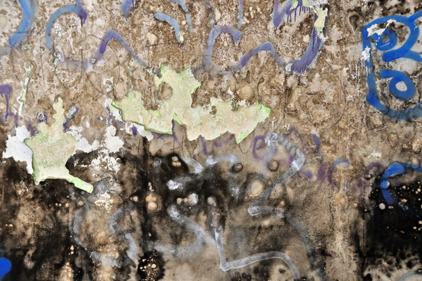 Old peeling grunge wall covered with messy graffiti and mold. Background texture. - Photo, Image
