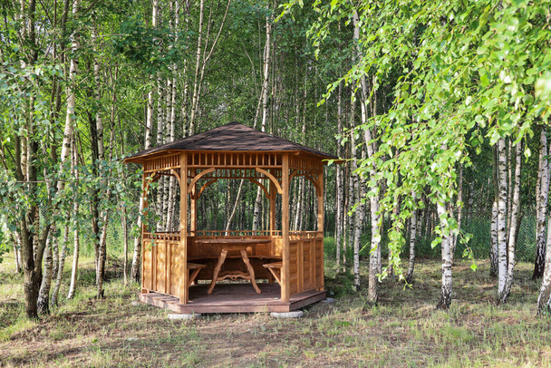 Summer open arbor gazebo from wood in birch grove on sunny day - Valokuva, kuva