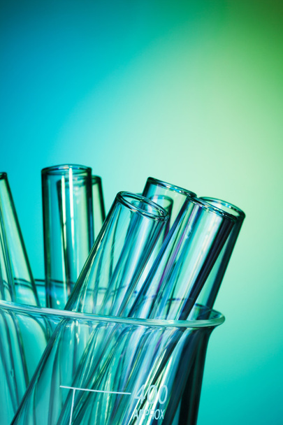 Glass test tubes together on the blue background - Фото, изображение