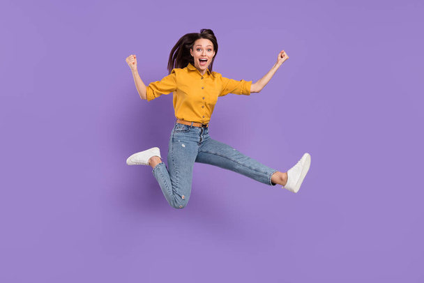 Full length body size photo jumping girl smiling overjoyed gesturing like winner isolated pastel purple color background - Foto, Imagem