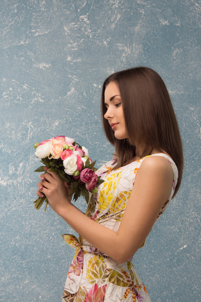 girl with bunch of flowers - Фото, изображение