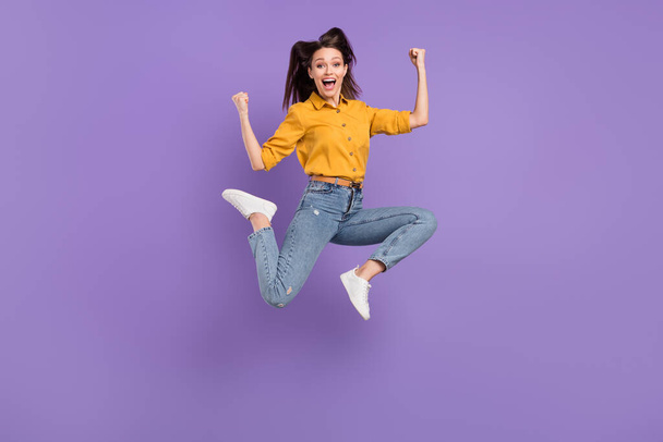 Full length body size photo jumping high girl smiling gesturing like winner isolated pastel purple color background - Φωτογραφία, εικόνα