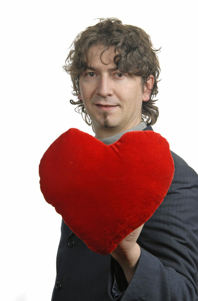 Man holding a red heart in the hand. On white background - Foto, afbeelding