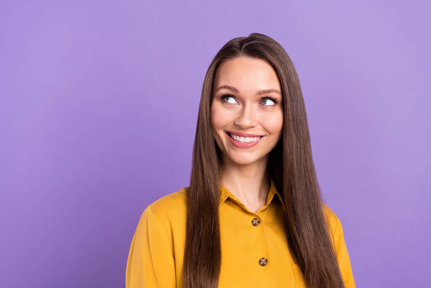 Photo of charming millennial lady look empty space wear yellow shirt isolated on violet color background - Фото, зображення